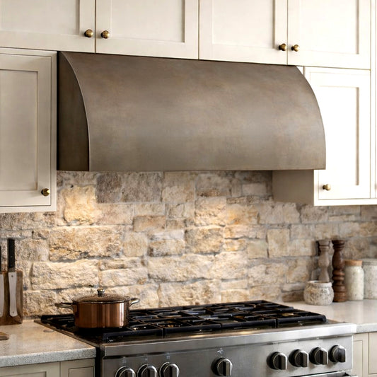 rustic under cabinet range hood with curve on stone backsplash